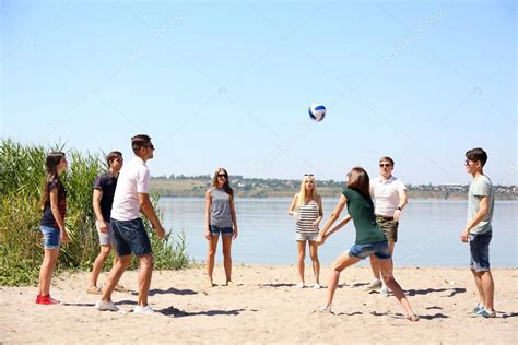 Playa con gente jugando voleibol