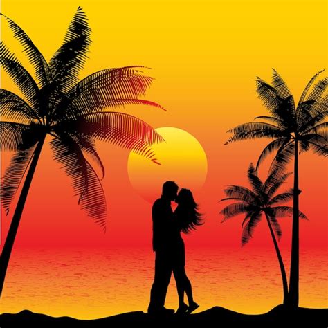 Siluetas de una pareja en la playa al amanecer