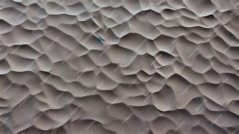 Ilustración de partículas de arena seca vs. arena mojada y su cohesión.